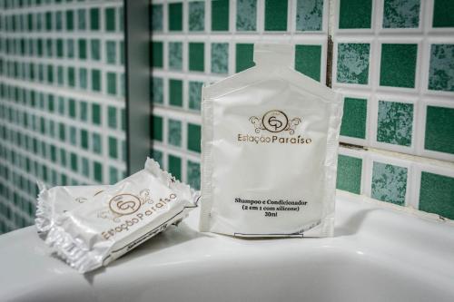 a bottle of soap and a packet of toothpaste on a bathroom sink at Hotel Estação Paraíso - ao lado do Metrô Paraíso e 600m da Av Paulista in Sao Paulo