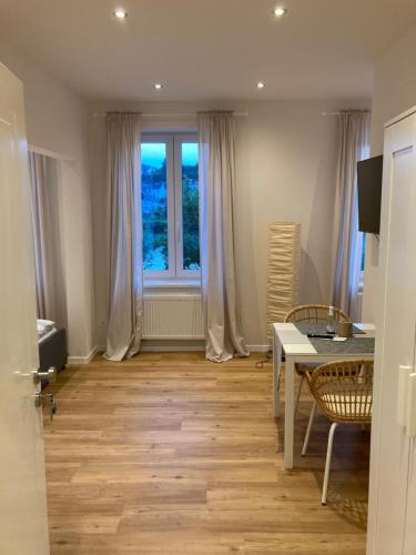 a living room with a table and a window at Apartment Hallenbach in Zell an der Mosel