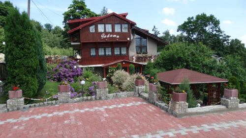 a house with a brick fence in front of it at Willa Padama in Szklarska Poręba
