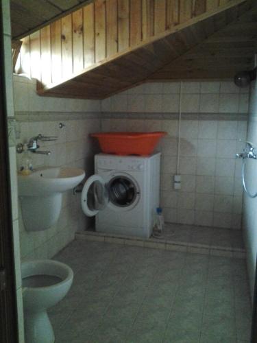 a bathroom with a washing machine and a sink at Paradise Bay Villas in Sozopol