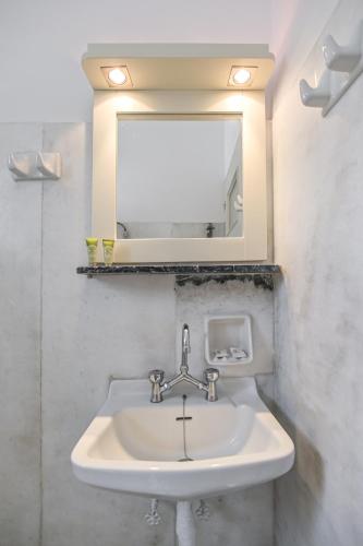 a sink in a bathroom with a mirror at Soula Naxos in Naxos Chora