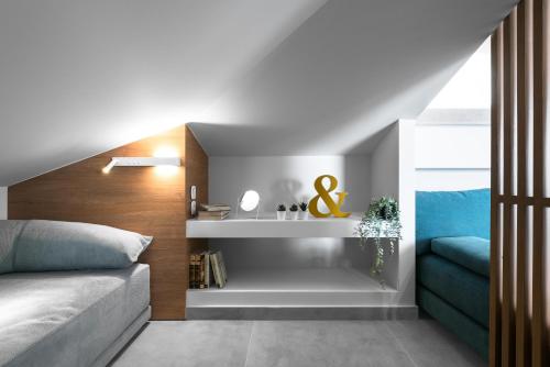 a bedroom with a bed and a shelf next to a window at Pola's loft in Ierissos