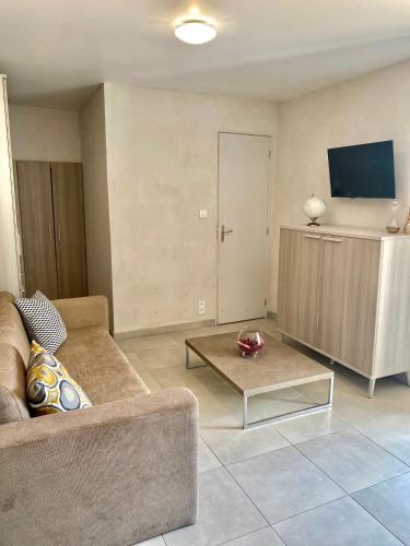een woonkamer met een bank en een salontafel bij STUDIO TERRASSE VUE MER Clim Wifi Parking in Partinello