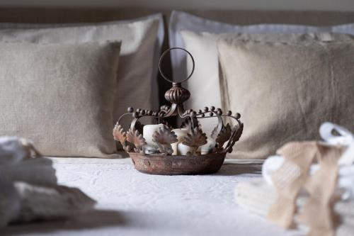 a basket on a bed with a mirror on it at Gipsy Maisonette in Lucca