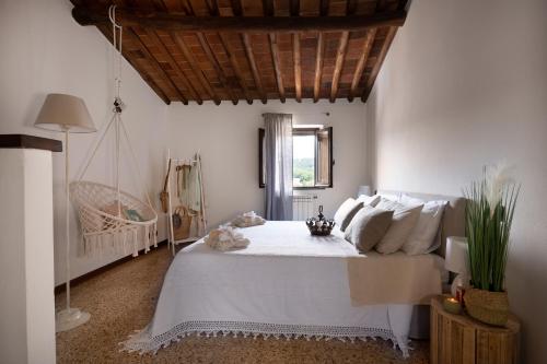 a bedroom with a large white bed and a swing at Gipsy Maisonette in Lucca