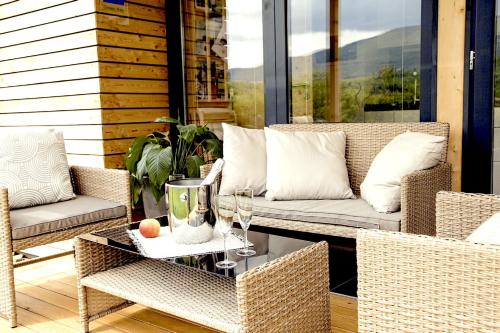 a patio with a couch and a table and chairs at MAXI SONCE, Odprte vasi in Prvačina