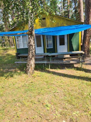 a yellow and green house with a blue roof at База відпочинку Енергія in Rudnya Peskovskaya