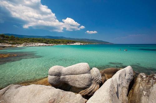 a view of a beach with rocks and the water at AZALEA HOTEL in Sarti