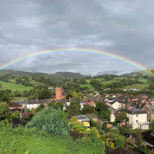 a rainbow over a town with a city at Old New Inn, Llanfyllin in Llanfyllin
