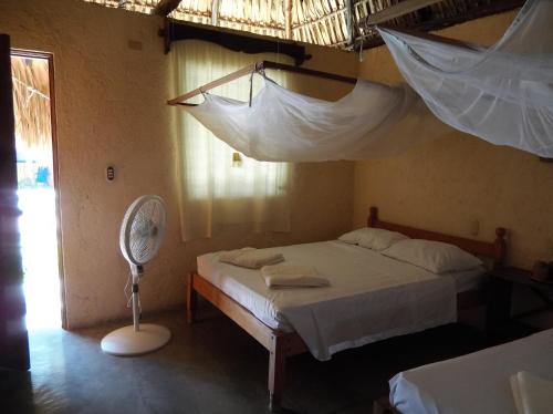 a bedroom with a bed with mosquito nets on it at Dulce y Salado in La Curbina