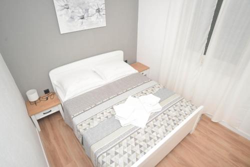 a small bedroom with a bed and a table at Apartment Ante in Biograd na Moru