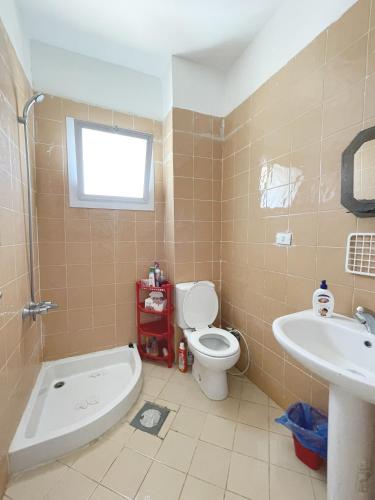 a bathroom with a toilet and a sink at 52H Green leaves Village, families & couples only in Dawwār Abū Duray‘ah ‘Abd al Karīm