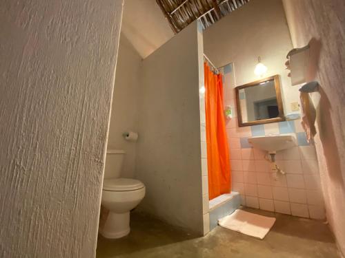 a bathroom with a toilet and a sink at Dulce y Salado in La Curbina
