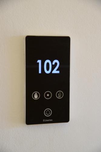 a switch on a wall with the clock on it at Viaros Hotel Apartments in Tolo