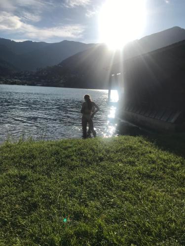 two people standing next to a body of water at Apartmany Lend in Lend