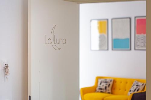 a living room with a yellow couch in a room at Apartamentos Rurales Cielo de Monfragüe in Malpartida de Plasencia
