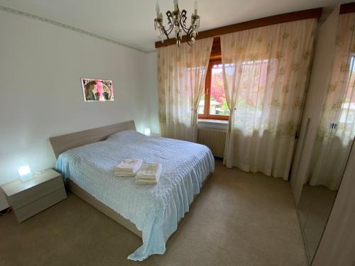 a bedroom with a white bed and a window at Discover Italy in Tignes
