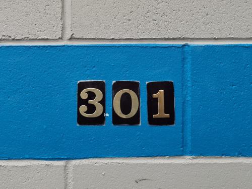 a sign on a wall with the number thirty one at Harringtons Motor Lodge in Palmerston North