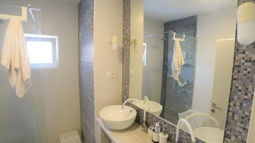 a bathroom with two sinks and a glass shower at The Duke in Šibenik