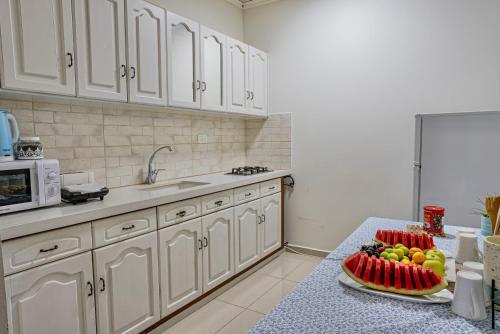 a kitchen with a table with a plate of fruit on it at toptop1 in Majdal Shams