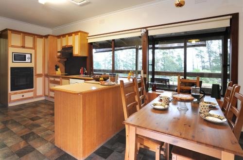 a kitchen with a wooden table and a dining room at Lavender Farm in Healesville