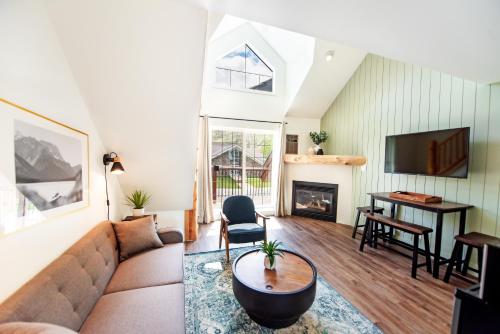 a living room with a couch and a table at Waterton Glacier Suites in Waterton Park