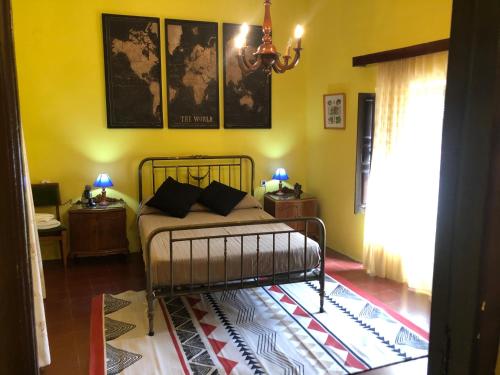 a bedroom with a bed in a room with yellow walls at Casa Virginia in Sacedón