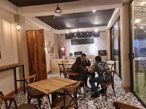 a group of people sitting at a table in a restaurant at Casa Hotel Bremen in Circasia