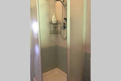 a shower with a glass door in a bathroom at Villa dei Pioppi in Fontane Bianche