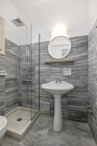 a bathroom with a sink and a shower and a mirror at Soula Naxos in Naxos Chora