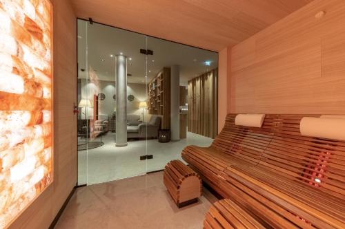 a wooden bench in a room with a bedroom at Der Unterschwarzachhof in Saalbach Hinterglemm