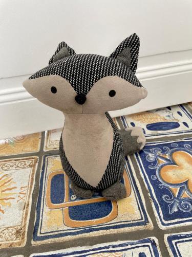 a stuffed fox toy sitting on the floor at le numero 100 in Nancy