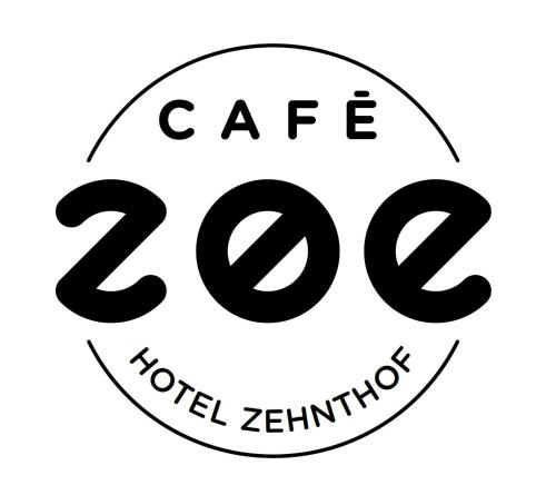 a stop sign with the text cafe and total zimbabwe at Hotel Zehnthof in Cochem