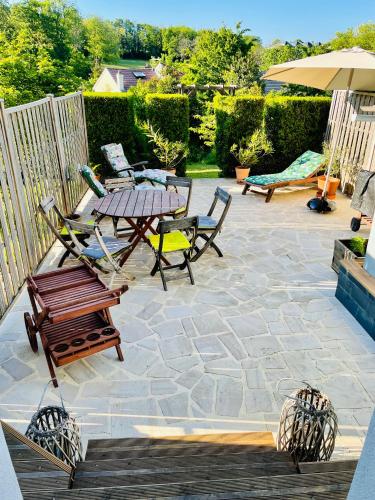a patio with a table and chairs and an umbrella at le numero 100 in Nancy