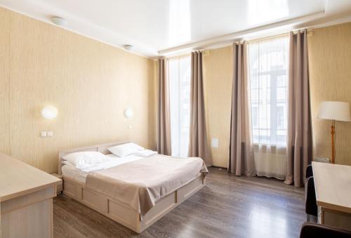 a hotel room with a bed and a large window at RA Kuznechny 19 in Saint Petersburg