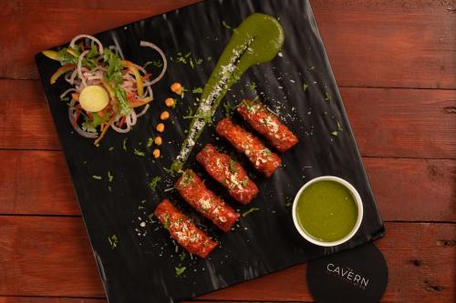 a black plate with some food on a table at CAG Pride in Coimbatore