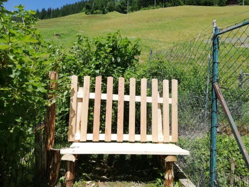 a wooden bench sitting in front of a fence at Ferienwohnung Spitaler Unterkofler in Hippach