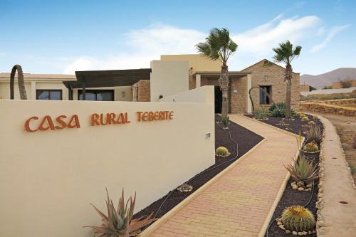a home in the desert with a sign for the casa rival fence at Casa Rural Teberite in Tuineje