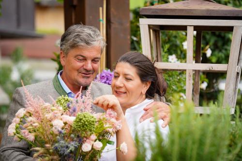 a man and a woman looking at flowers at Der Unterschwarzachhof in Saalbach Hinterglemm