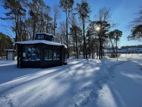 a gazebo in the snow in a park at Hotel Residenz WALDOASE in Ahlbeck
