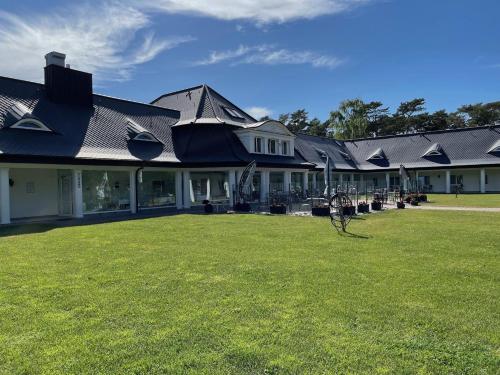 a house with a lawn in front of it at Hotel Residenz WALDOASE in Ahlbeck