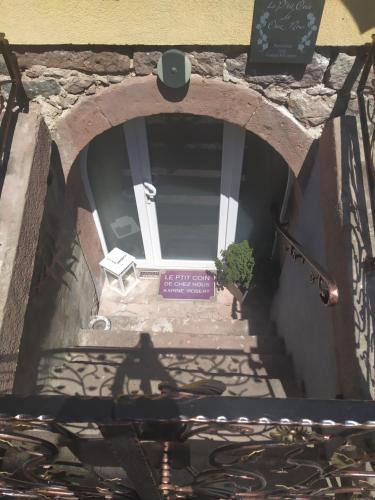 a shadow of a person walking down a stairway at Le p'tit coin de chez nous in Dambach-la-Ville