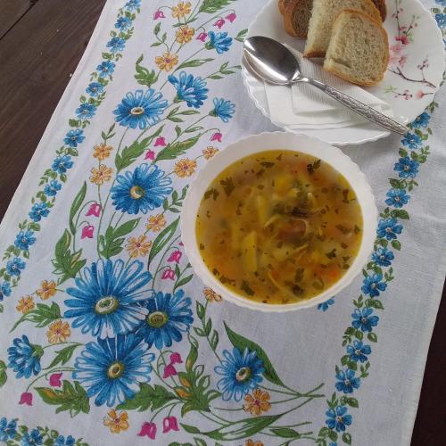 a bowl of soup on a table with a plate of bread at Садиба "У стрийка" Сопіт in Sopot