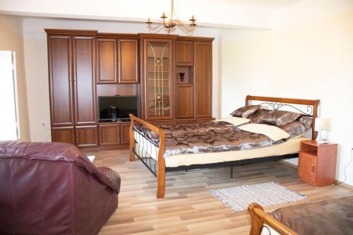 a bedroom with a large bed in a room at Gyöngyöm Apartman in Balatonalmádi