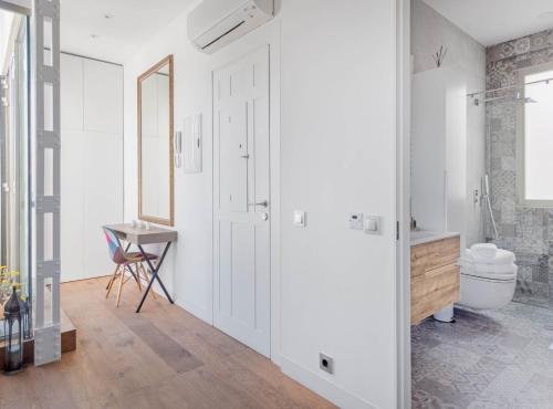 a white bathroom with a toilet and a sink at ALCALA III in Madrid