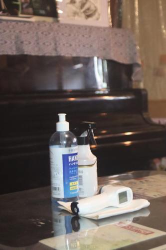 a bottle of hair lotion and a pair of scissors at Gallery Nozawa Inn in Kyoto