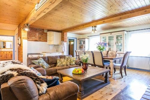 a living room with a couch and a table at Käbruotsa farmhouse in Ruhve