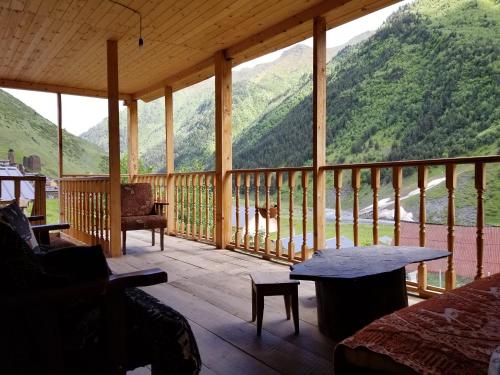 a screened in porch with a view of a mountain at Makratela in Akhmety