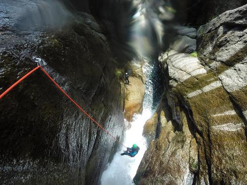 a person on a rope in a waterfall at BALMA DEI CUP con SPA privata su richiesta in Pont Canavese