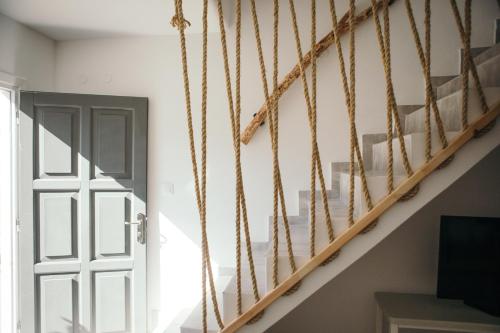 a staircase in a room with a door at Exi Sea Side Suites in Perissa